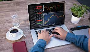 A person is using a laptop to trade stocks.